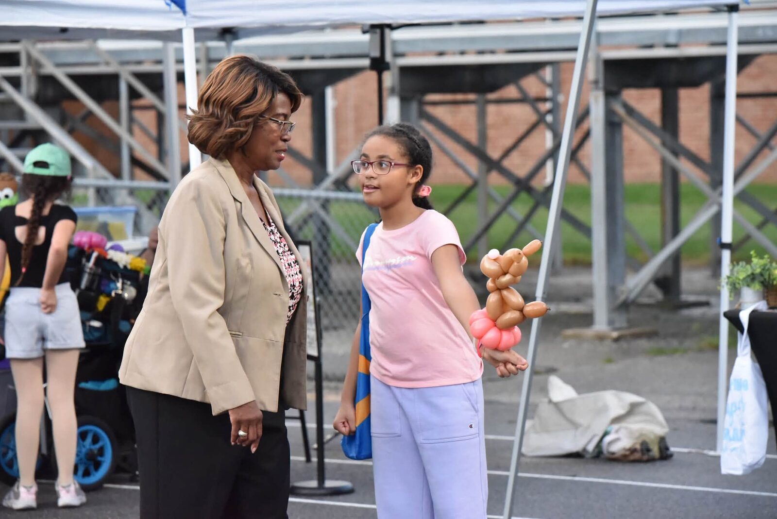 A young guest visits with a community leader